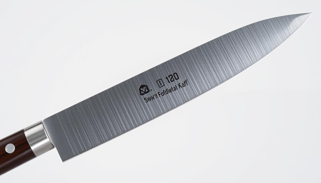 A high-quality, meticulously detailed close-up image of a professional 7-inch Shun chef's knife against a neutral background. The knife's blade is razor-sharp, gleaming under bright, even lighting. The handle is made of dark, finely-grained wood, with a subtle textured grip. The blade's profile is slender and tapered, with a seamless transition from the handle. The composition showcases the knife's precision, balance, and premium craftsmanship, emphasizing its versatility as a kitchen essential.
